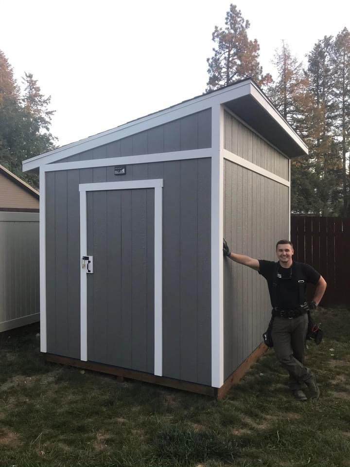 Newly constructed shed with a man standing next to it by Panhandle Contracting Co. in Rathdrum, ID
