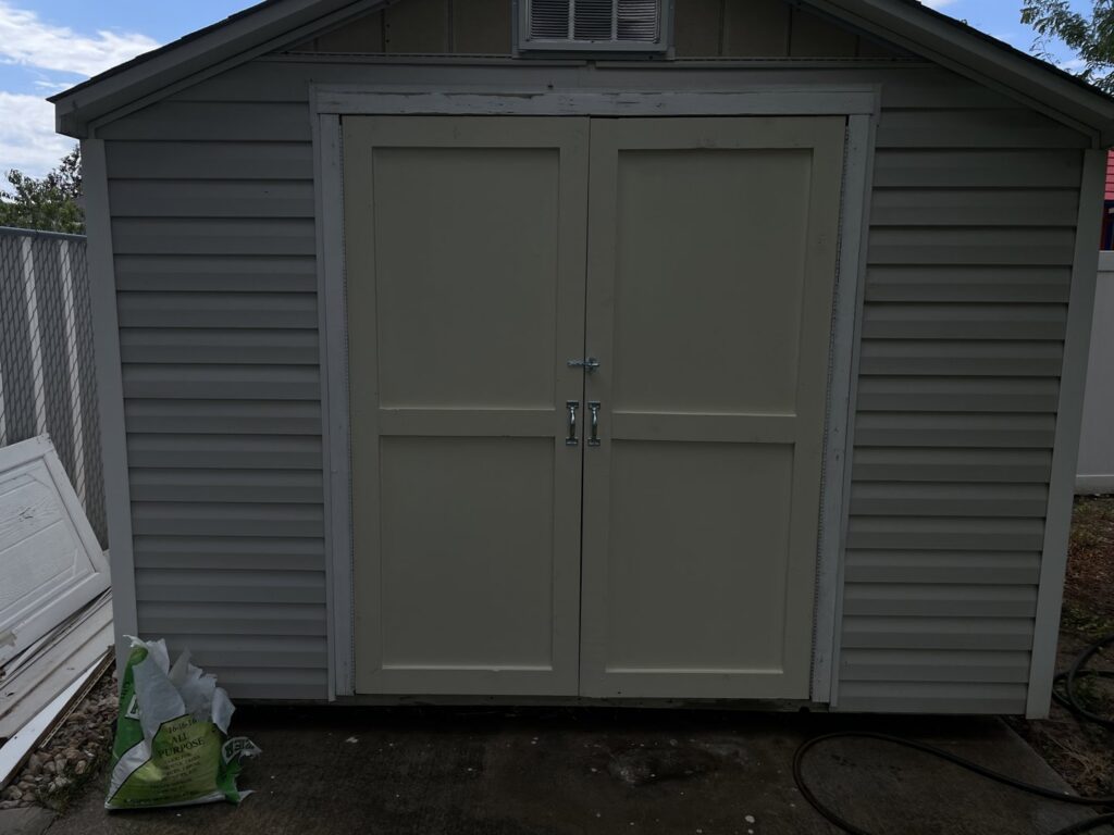 New double doors installed on an outdoor shed by Jonny Handyman Services in Roy, UT.