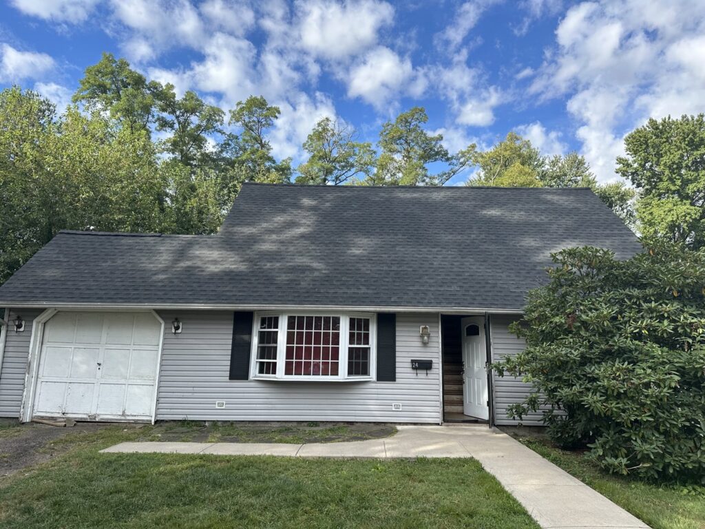 A residential house with a new shingle roof installed by RHI Construction Inc in Philadelphia, PA.