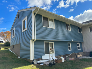 A house with newly installed blue siding and gutters, completed by GGS General Construction LLC in Plano, TX.