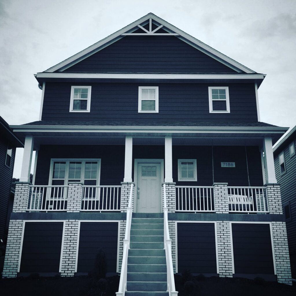 The exterior of a house with new siding and seamless gutters installed by Gutter Flow7 LLC in Madison, WI.