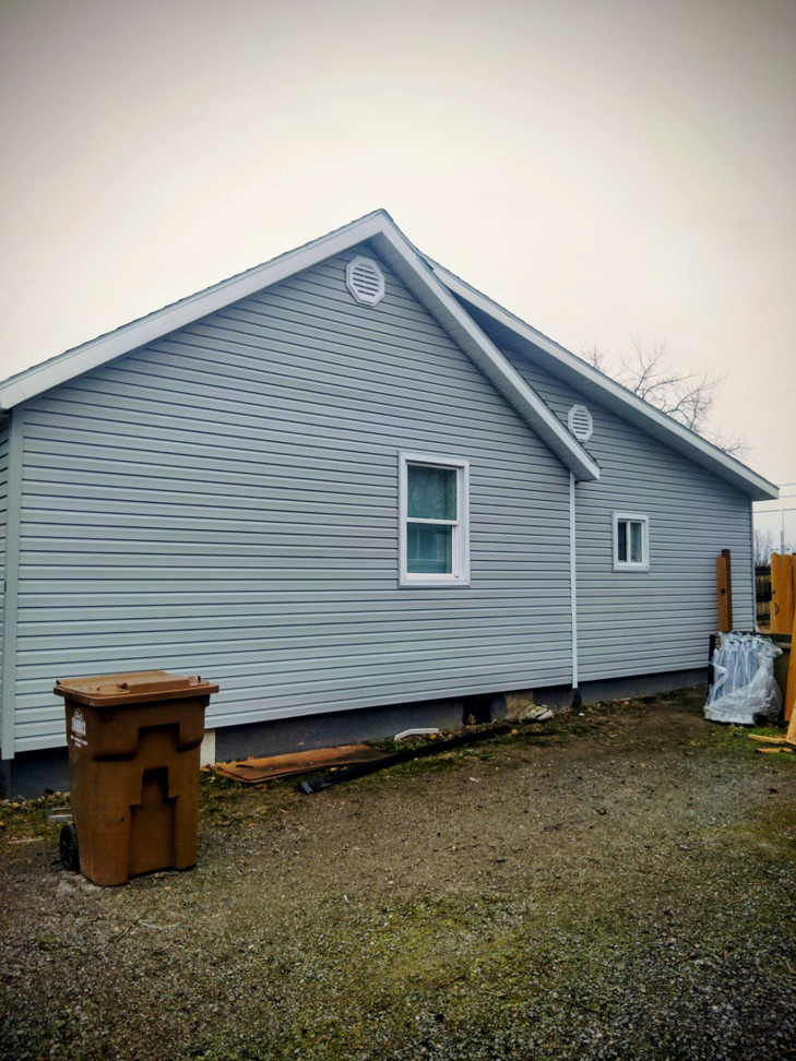 Newly installed gray siding and vents on a house exterior by Investment Handyman Services in Pocatello, ID