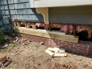 Newly installed wooden sill beams on a house exterior during replacement by Richard C. Michalak in Worcester, MA.