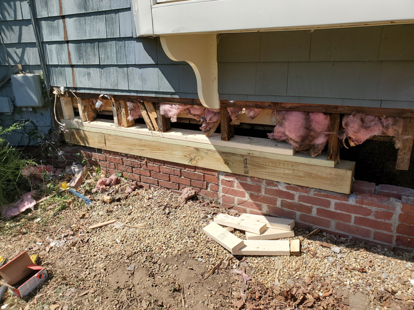 Newly installed wooden sill beams on a house exterior during replacement by Richard C. Michalak in Worcester, MA.