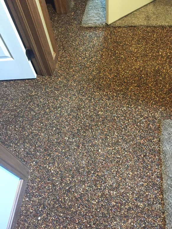 A newly installed speckled epoxy floor in a home by Kline Custom Homes and Remodelers in Canton, OH.