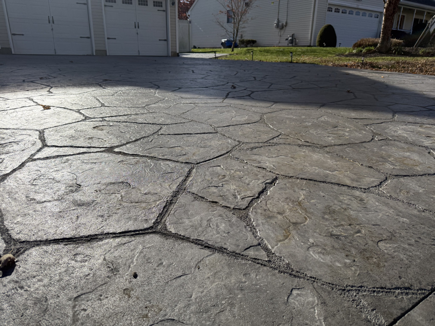A newly installed stamped concrete driveway or walkway showcasing quality craftsmanship by Delco Contracting in Toms River, NJ.