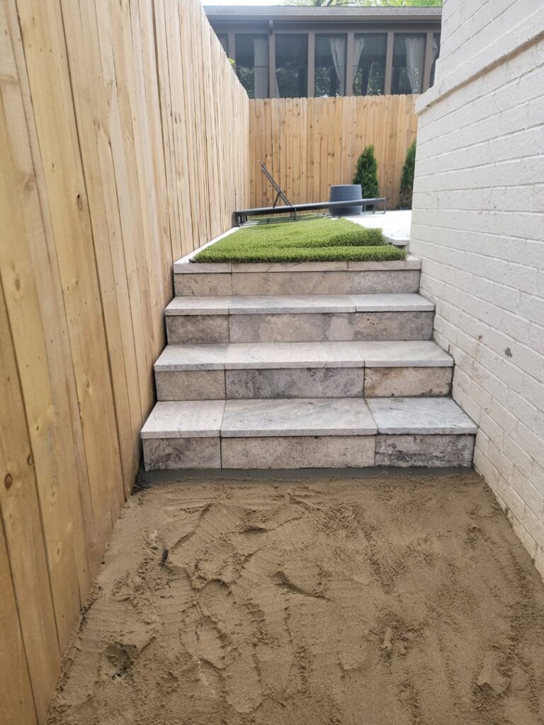 New stone steps installation next to a fence by Gonzalez Services Corp. in Nashville, TN.