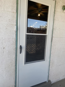 King's Men installing a new white storm door for a client in Las Cruces, NM.