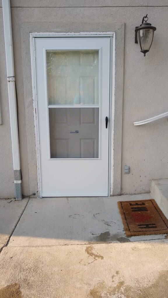 New white storm door installation completed by Shane's Handyman Service in Edmond, OK.