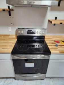 New stove and range hood installation in a kitchen by Becker Custom Construction - pdx in Oak Grove, OR.