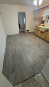 Newly installed tile flooring in a kitchen undergoing renovation by Rosado Brothers in Chicago, IL