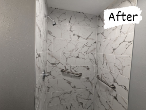 A newly tiled shower with modern white marble-look tiles and grab bars installed by Joel's Handyman in Ogden, UT.
