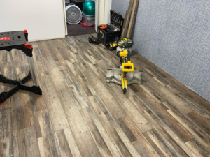 New vinyl plank flooring being installed in a room by North Shore Construction & Renovation in Philadelphia, PA.
