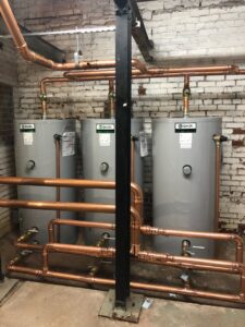 New water heater installation with intricate copper piping by JF Plumbing & Heating in Rockville, MD.