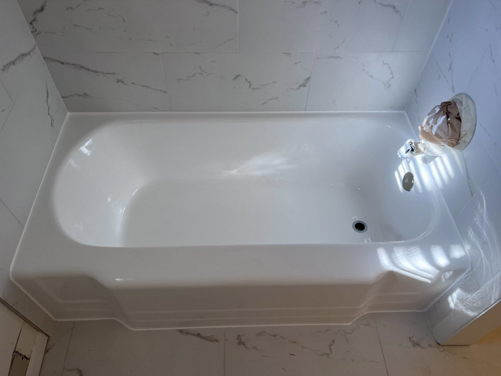 A newly refinished white bathtub in a modern bathroom by Immaculate Refinishing in Arlington, TX.
