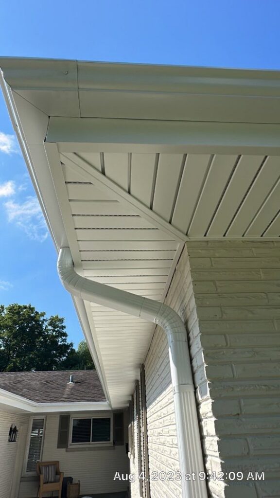 Newly installed white gutters, soffit, and fascia on a house by Pro Home Solutions in Aiken, SC.