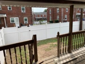 Installation of a new white vinyl fence in a backyard by Creative Touch Renovations LLC in Harrisburg, PA.
