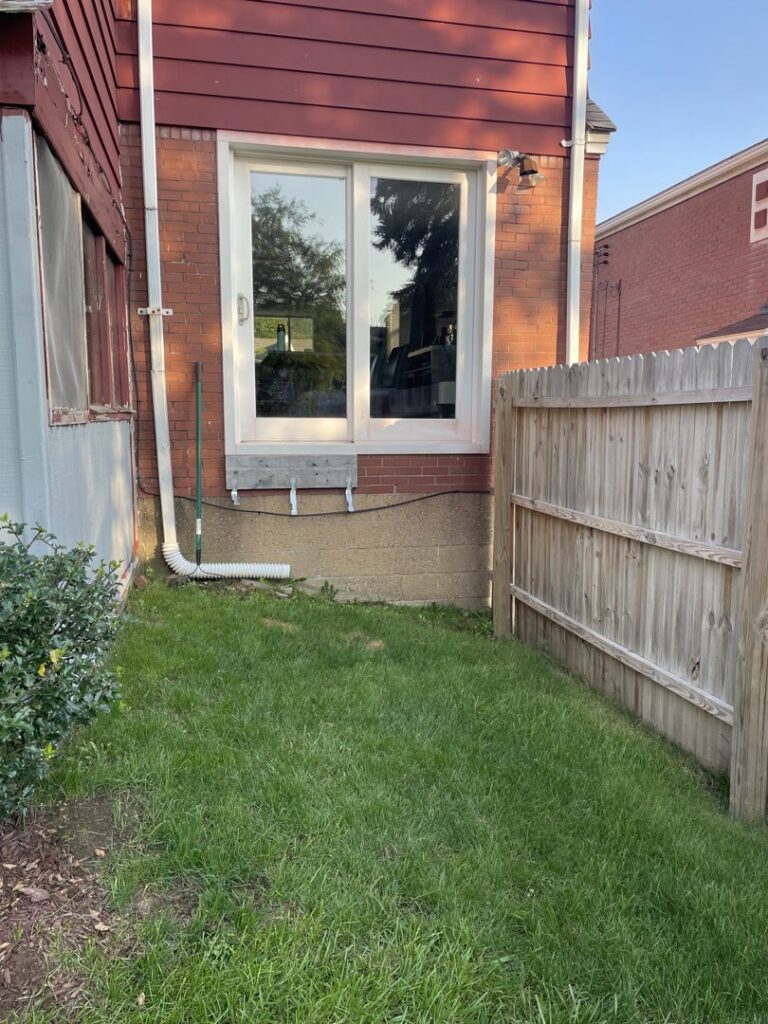 A newly installed window on the side of a house, showcasing exterior renovation work by Gold-Mine Construction, LLC in Pittsburgh, PA.
