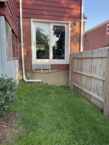A newly installed window on the side of a house, showcasing exterior renovation work by Gold-Mine Construction, LLC in Pittsburgh, PA.
