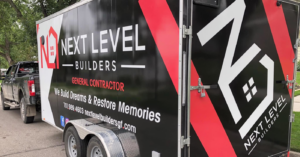 New window installation on a grey-sided house by Next Level Builders, Inc. in Grand Forks, ND.