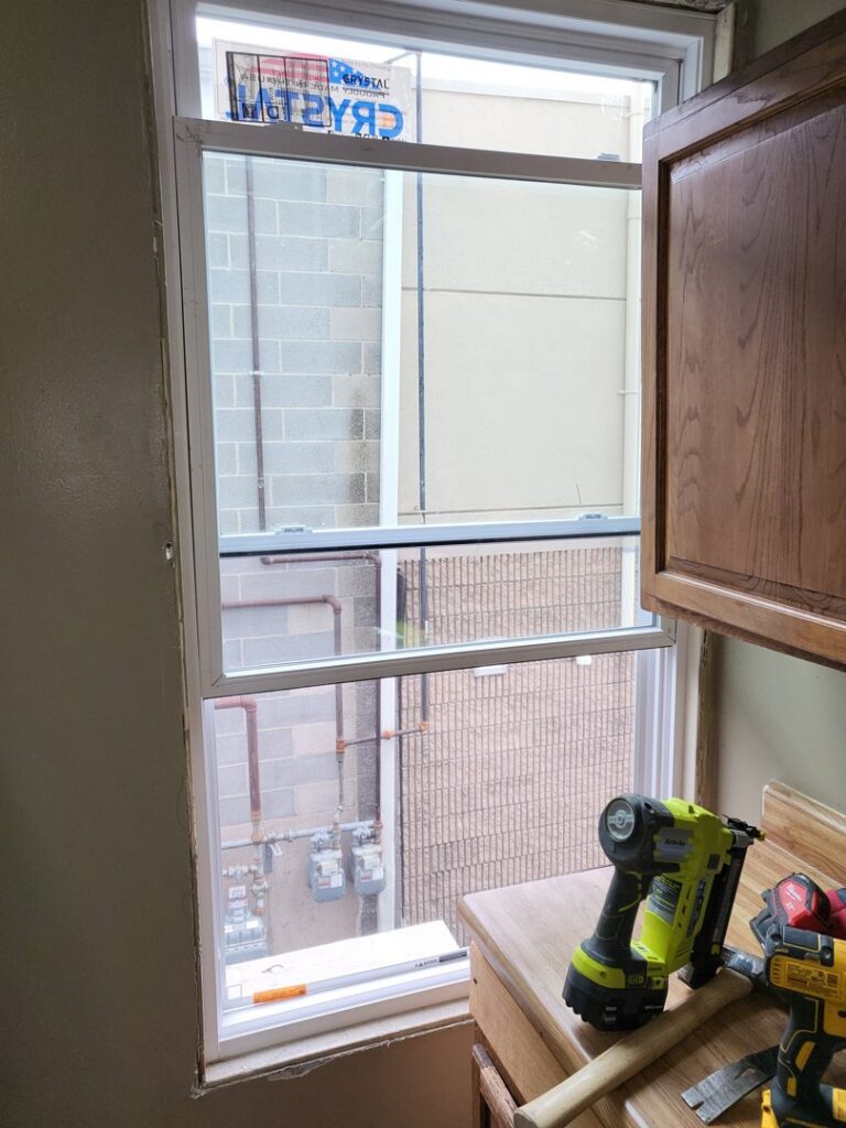 New window installation with tools on the countertop by Green Man's Contracting & Landscaping LLC in West Hartford, CT.