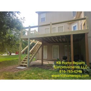 A newly constructed wooden deck with stairs leading to the backyard, built by KB Home Repairs & Improvements, LLC in Shawnee, KS.