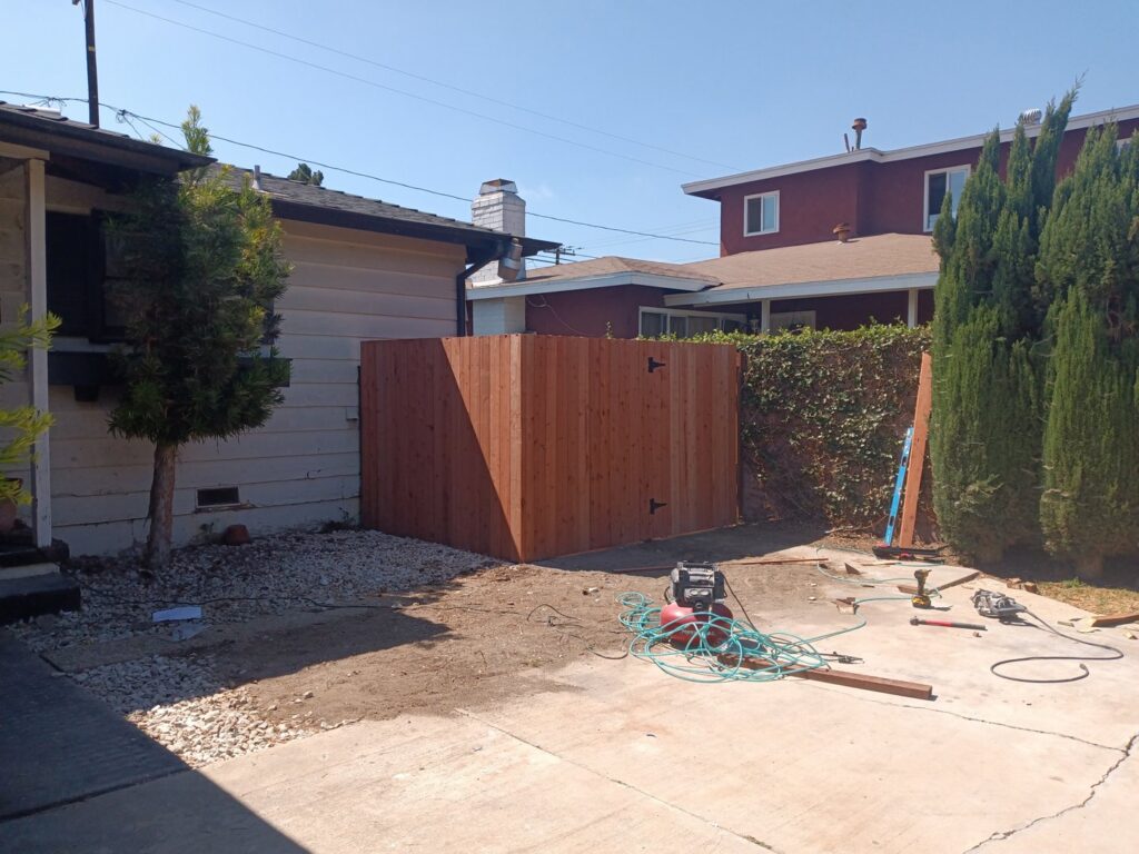 A newly installed wood fence or gate section in a backyard, a project by Juancho's Handyman in Salida, CO.