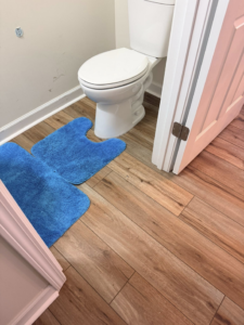 Durable wood-look plank flooring installed in a bathroom by Master Renovations LLC in Englewood, CO.