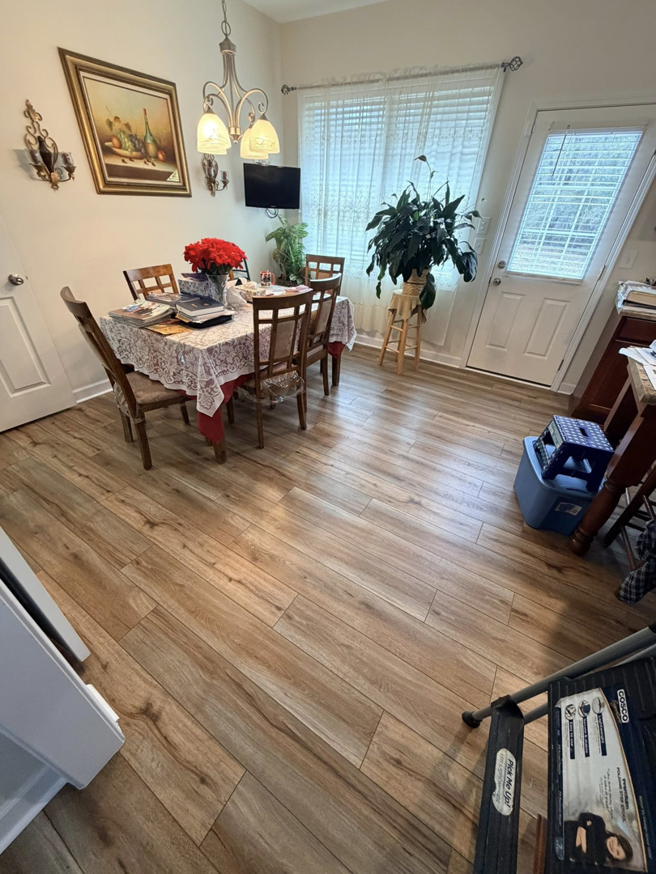Beautiful new wood-look plank flooring installed in a dining room by Master Renovations LLC in Englewood, CO.