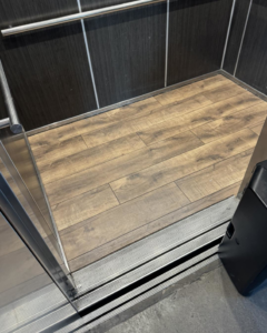 Newly installed wood-look flooring inside an elevator by Eddie of all trades in Peoria, AZ