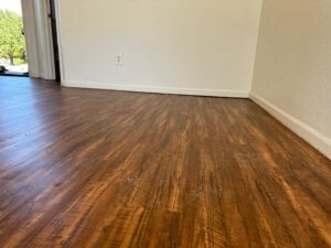Beautiful new wood-look flooring installed in a residential room by MDN Roofing 2 Flooring LLC in Fort Worth, TX.