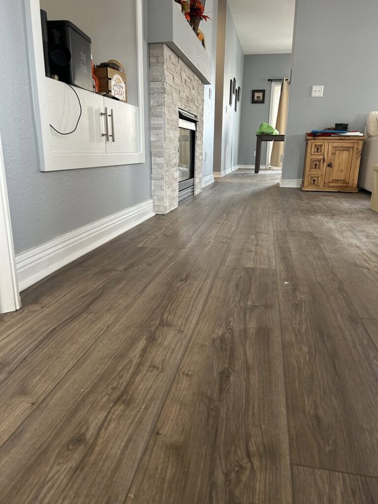 Newly installed wood-look flooring in a home's living area, a service provided by Wam Bam Handyman LLC in Colorado Springs, CO