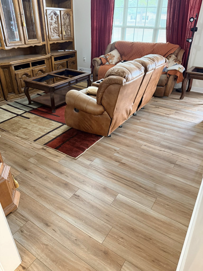 Modern wood-look plank flooring installed in a living room by Master Renovations LLC in Englewood, CO.