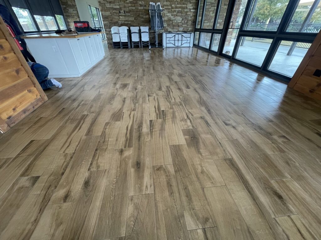 Newly installed wood-look tile flooring in a residential space by R and R contractors in Rogers, AR.