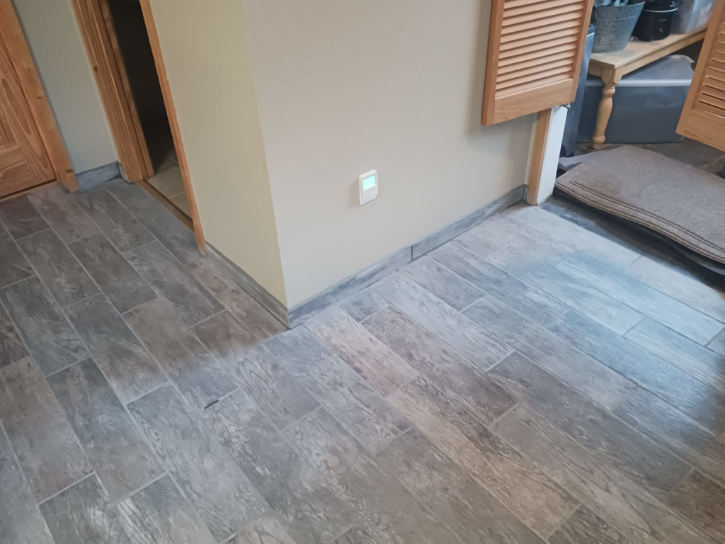 Newly installed wood-look tile flooring in a home, a project completed by RS handyman llc in Kenai, AK.