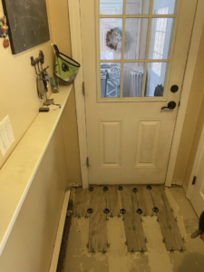 New wood-look tile installation in progress with leveling spacers by Main Street Handyman, LLC in Winter Garden, FL.