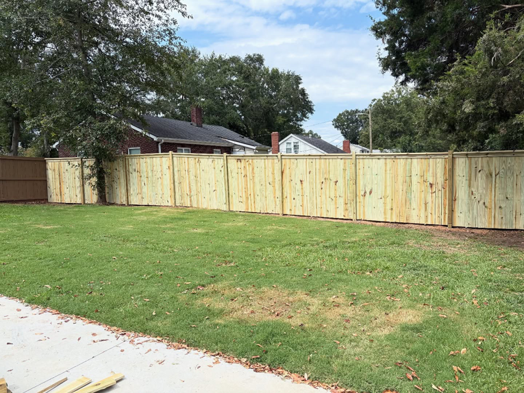 Newly installed wood privacy fence in a backyard by BZB Fencing & Staining in Fountain Inn, SC.