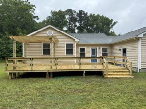 A newly constructed wooden deck with an attached pergola, completed by Dutch Deck and Fence in Norfolk, VA.