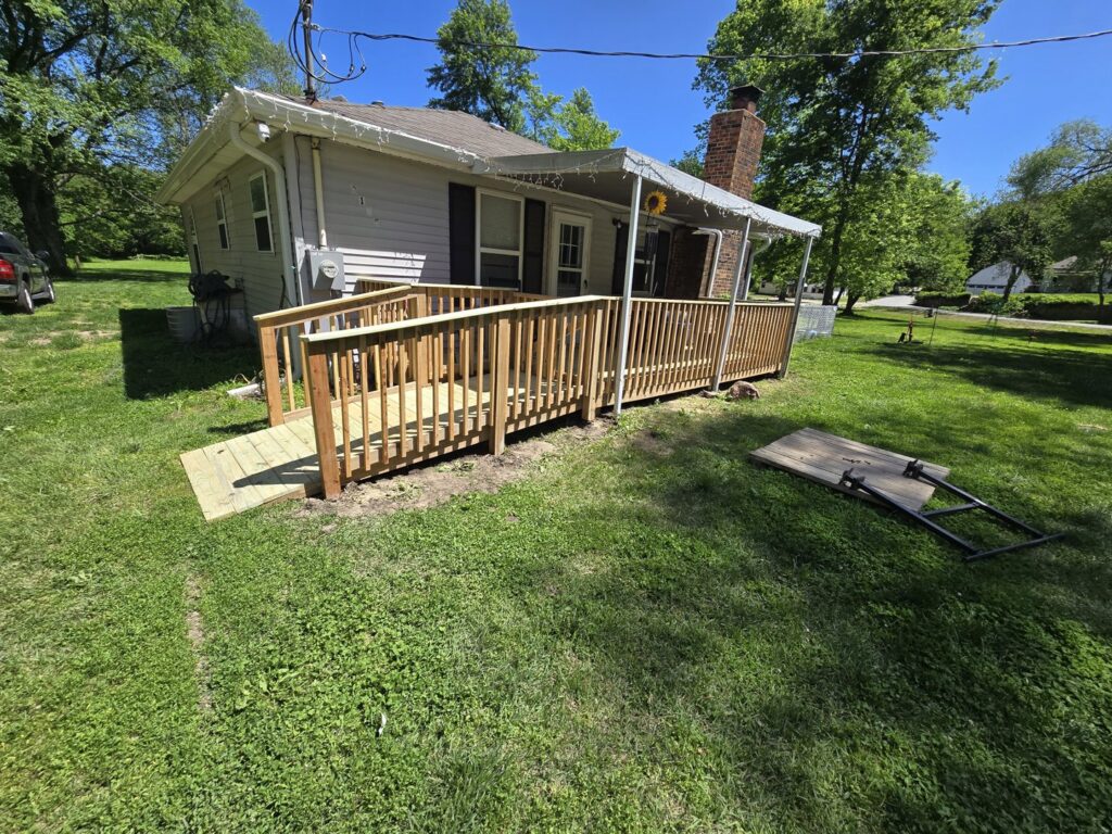 A newly constructed wooden deck and accessibility ramp by Gateway Home Services KC LLC in Kansas City, MO.