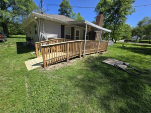 A newly constructed wooden deck and accessibility ramp by Gateway Home Services KC LLC in Kansas City, MO.