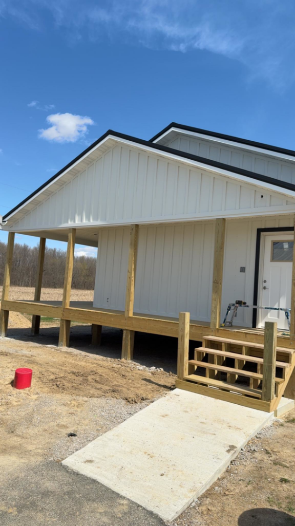 Construction of a new wooden deck and stairs on a white-sided house by Phillip's Home Repair in Owensboro, KY