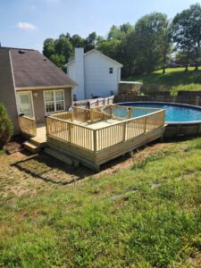 A newly constructed wooden deck built around an above-ground swimming pool by Richwood Remodeling & Outdoor in Nashville, TN.