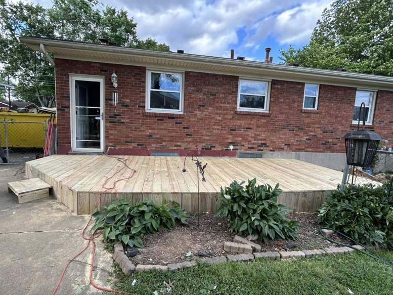 A newly constructed wooden deck attached to a brick house by A2 Construction in Louisville, KY.
