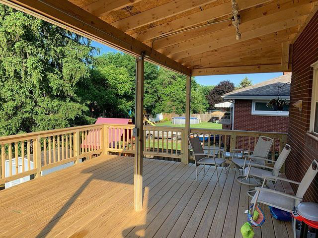 A newly constructed wooden deck with a covered pergola, built by McIntyre's Renovations LLC in Pittsburgh, PA