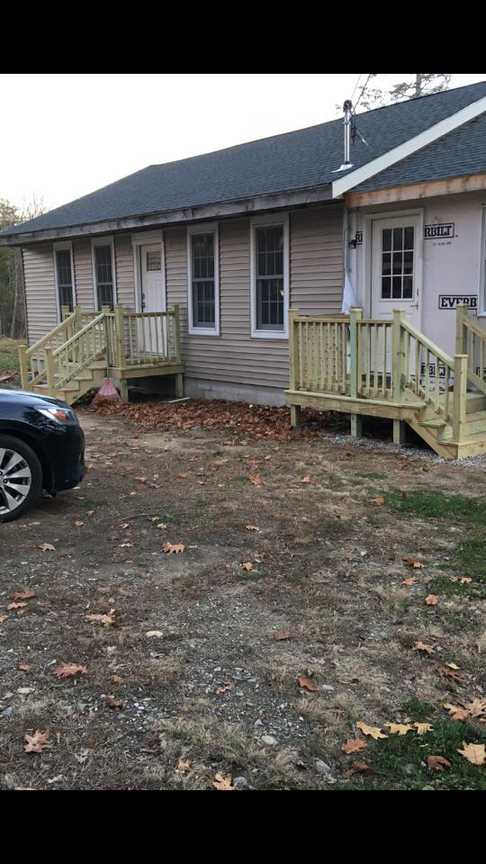 Newly constructed wooden decks and porches on a house exterior by Two Girls Cleaning Services in Brunswick, ME.