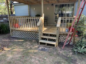 New wooden deck construction with stairs by Wall Doctor's Plastering LLC in Tallahassee, FL