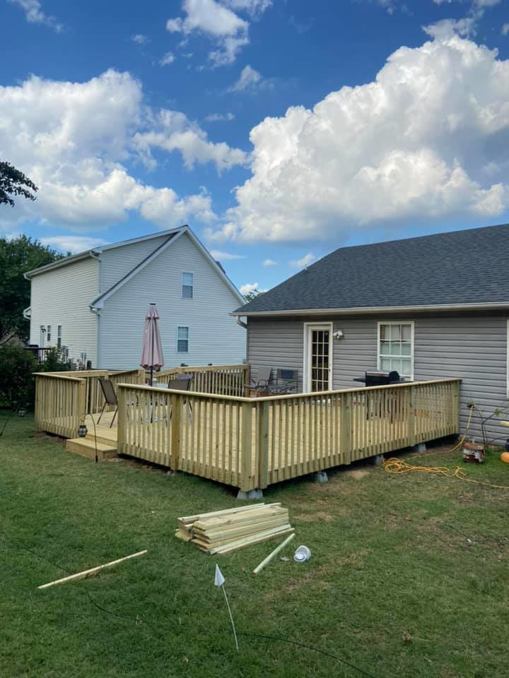 A new wooden deck installation in a backyard by LDT Construction Services in Spring Hill, FL.