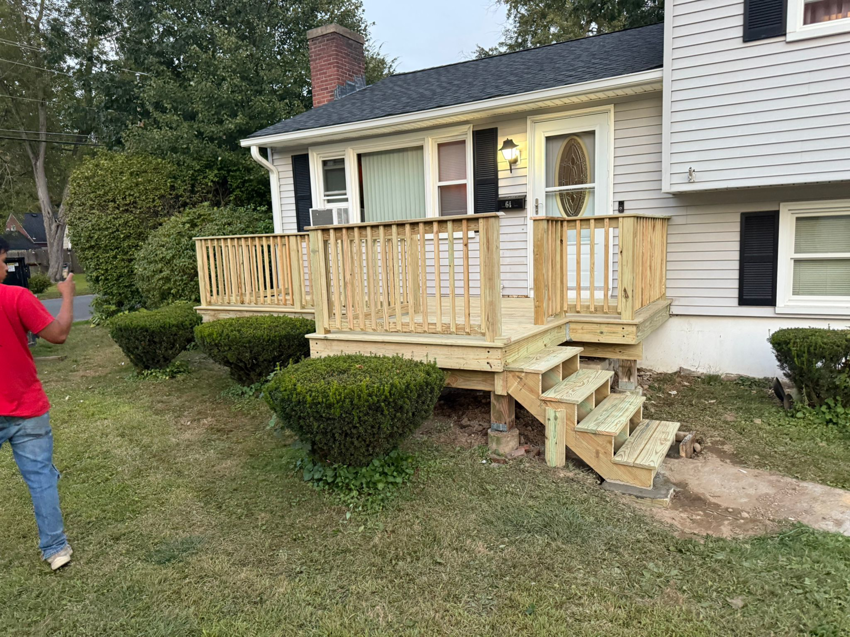 A newly constructed wooden deck and stairs on a house by Leo Brothers Contracting in Danbury, CT.