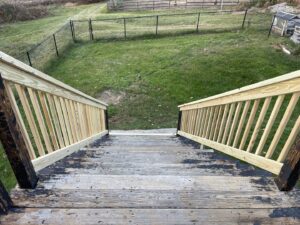 Newly installed wooden deck railings on an outdoor deck, a home improvement project by Granite State Handyman & Home Repair in Derry, NH.