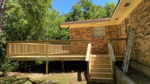 A newly constructed wooden deck with stairs, showcasing outdoor living space improvement by SMM Services LLC in Gulfport, MS.